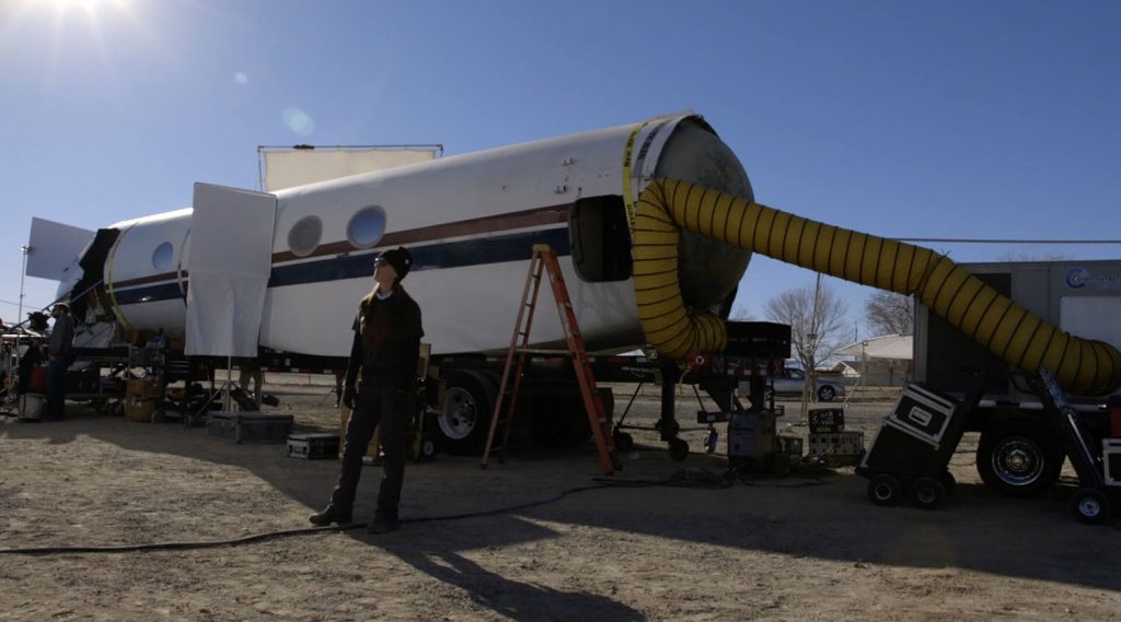 Film crew working on a mock up of a jet