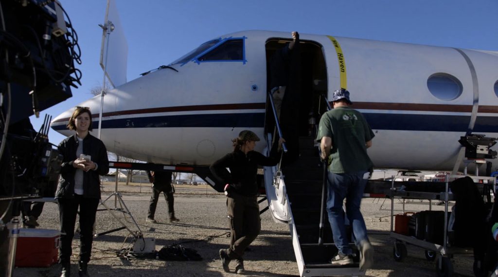 Film crew working on a mock up of a jet