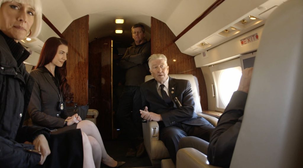 David Lynch and fellow actors and crew inside a jet