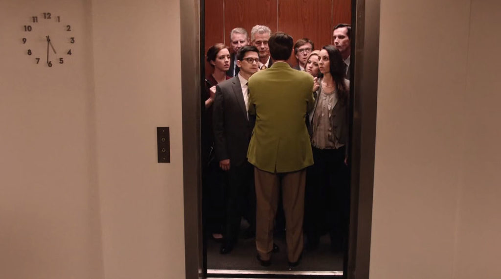 Dougie Jones standing in a crowded elevator