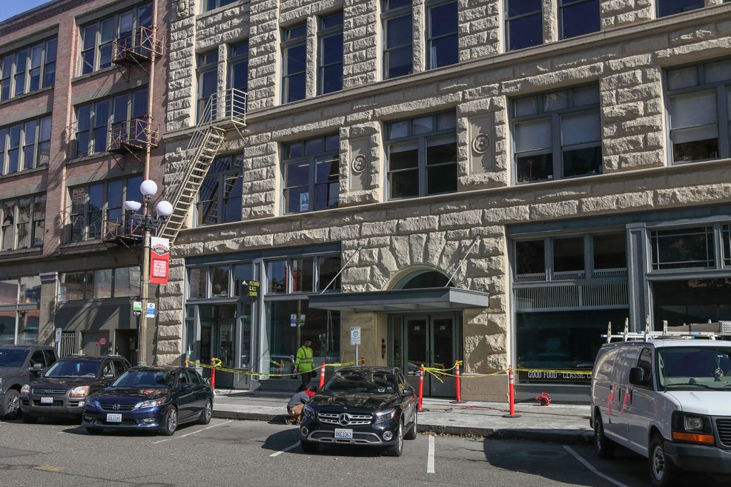 Exterior of Baker Building in downtown Seattle with cars parked along the street.