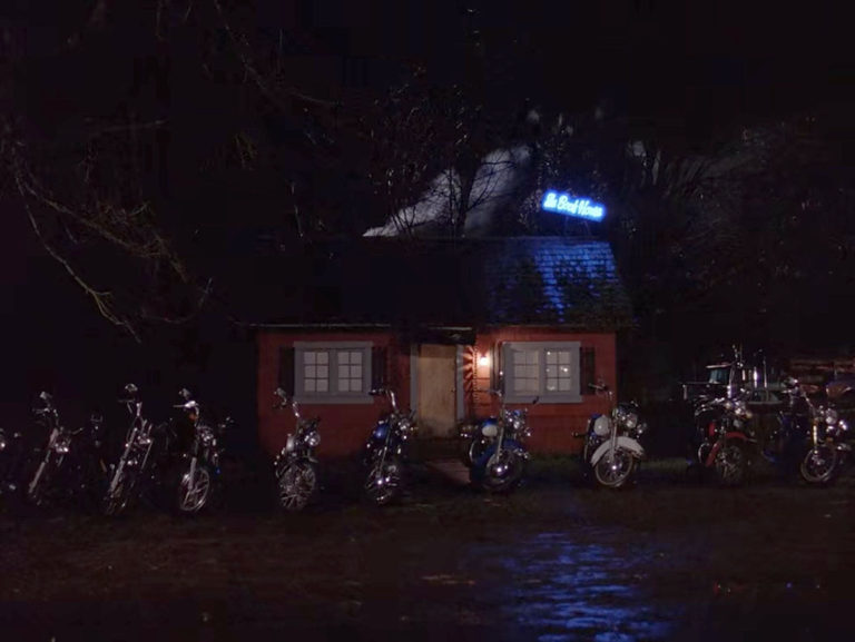 The Bookhouse at night with motorcycles parked outside