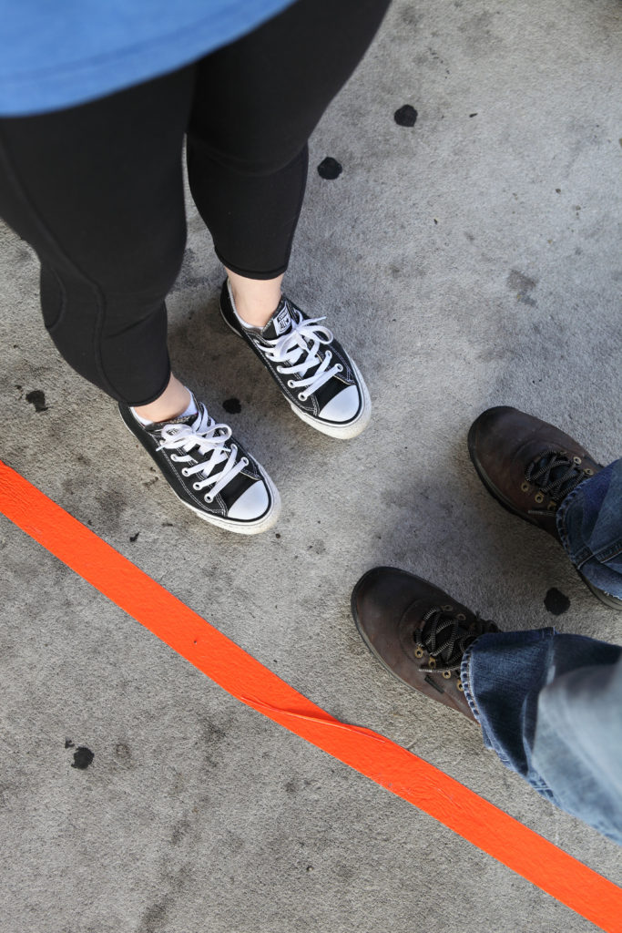 Two people standing by a line