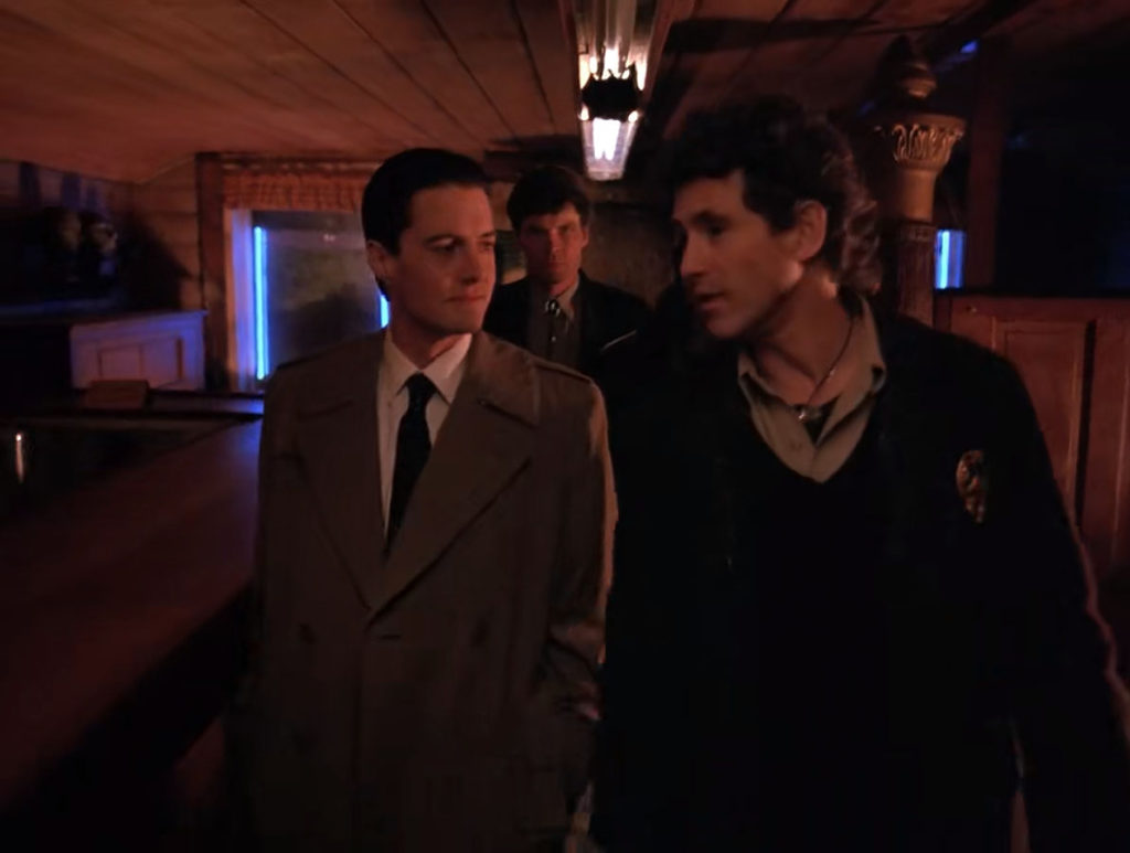 Cooper, Truman and Big Ed Hurley walk through the Bookhouse