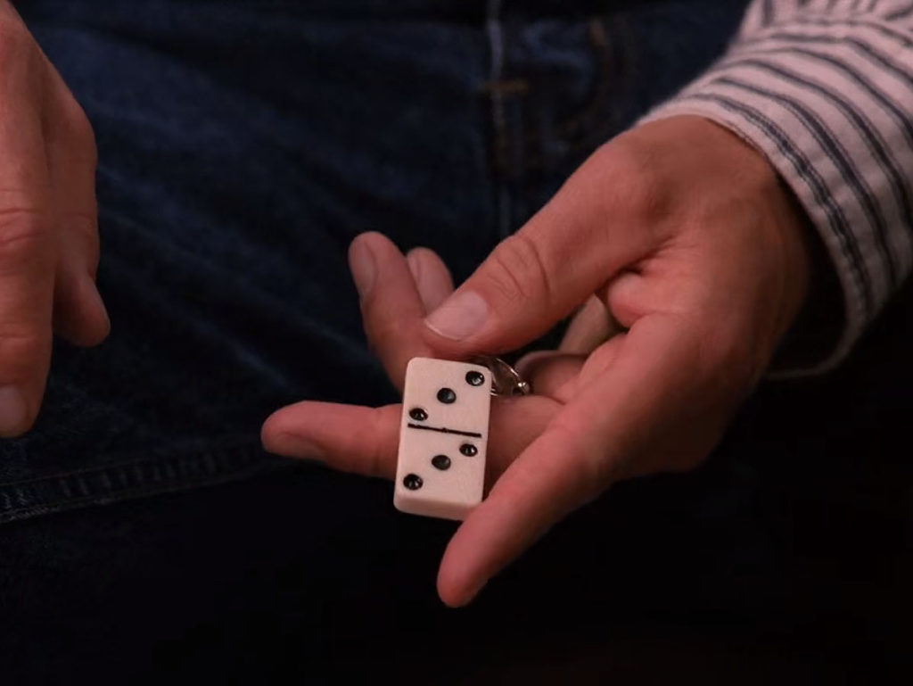 Hank Jennings holding a 3 / 3 domino key chain