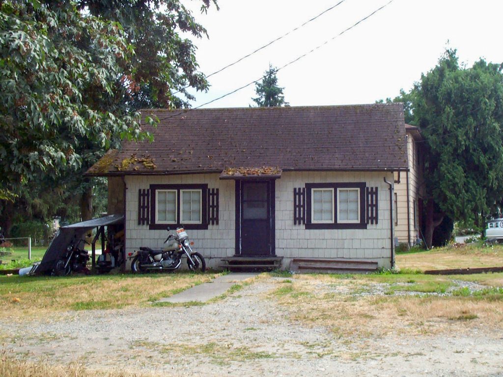 The Bookhouse, small house with brown roof and cream-colored siding