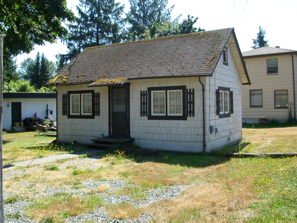 The Bookhouse, small house with brown roof and cream-colored siding