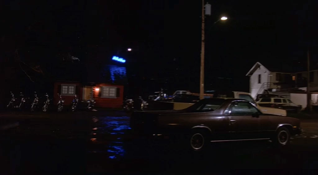 Bookhouse and Roadhouse with cars in lot at night