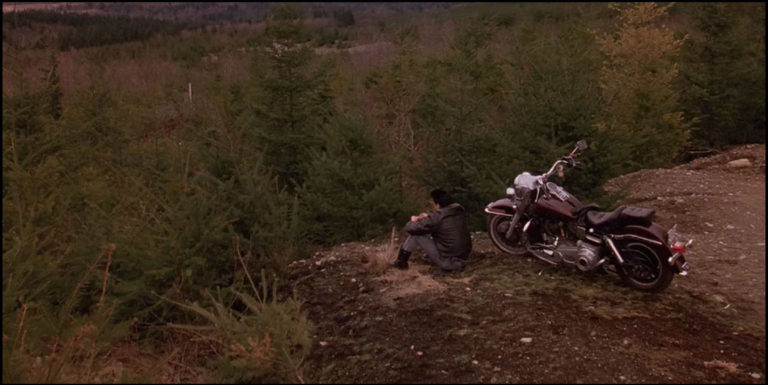 James Hurley sitting on a mountain overlook