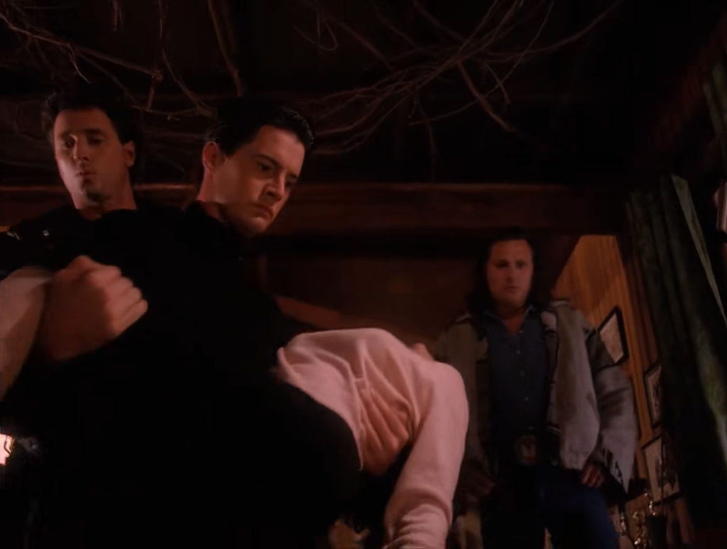 Agent Cooper carrying Audrey Horne as Hawk follows