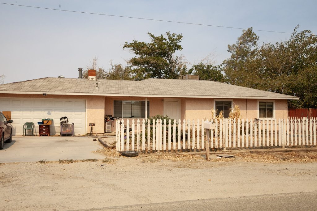 One-story house with a white fence