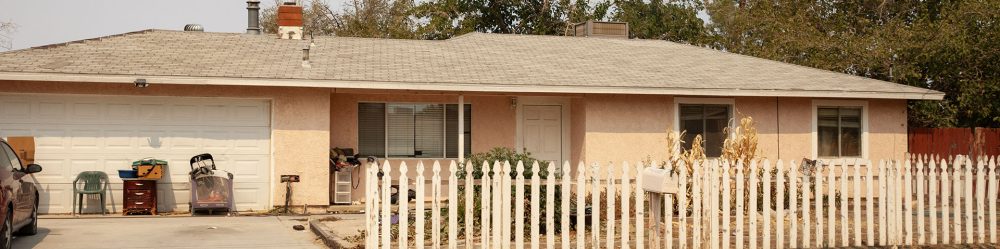 One-story house with a white fence