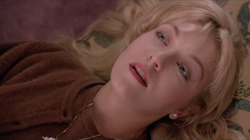 Laura Palmer laying on the chair at the Hayward's house