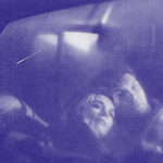 Blue-hued image of Norma Jennings and Ed Hurley in Ed's truck