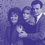 Blue-hued image of family photo with Sarah, Laura and Leland Palmer standing next to each other in their dining room.