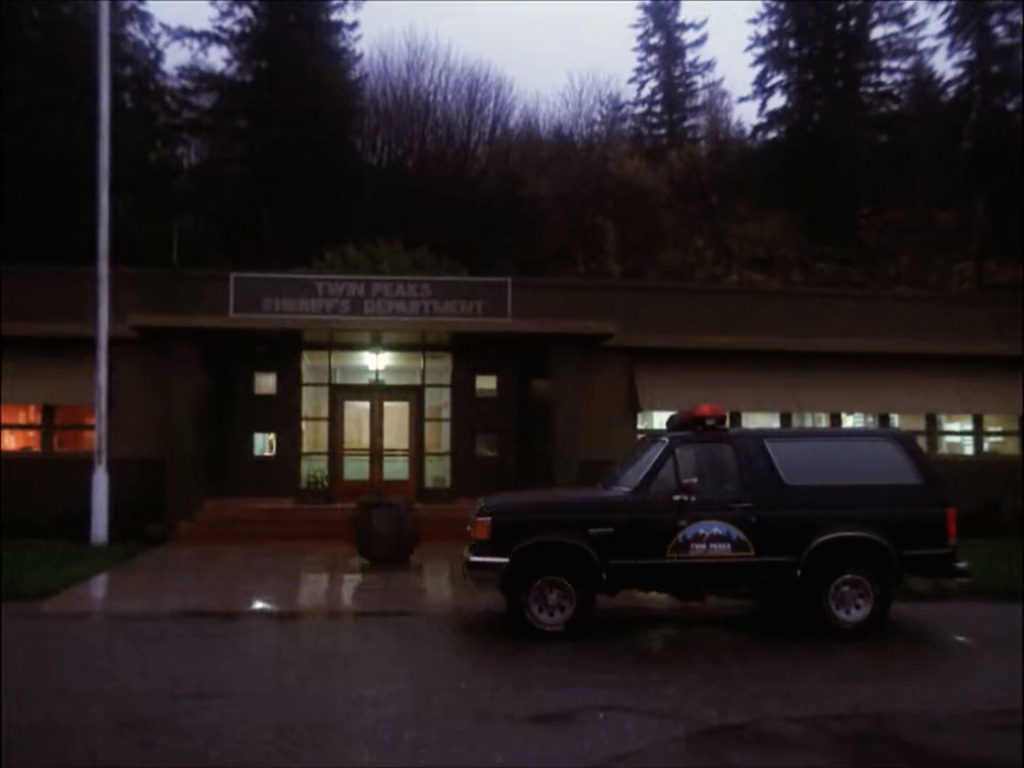 Exterior of Twin Peaks Sheriff's Department with police Bronco truck