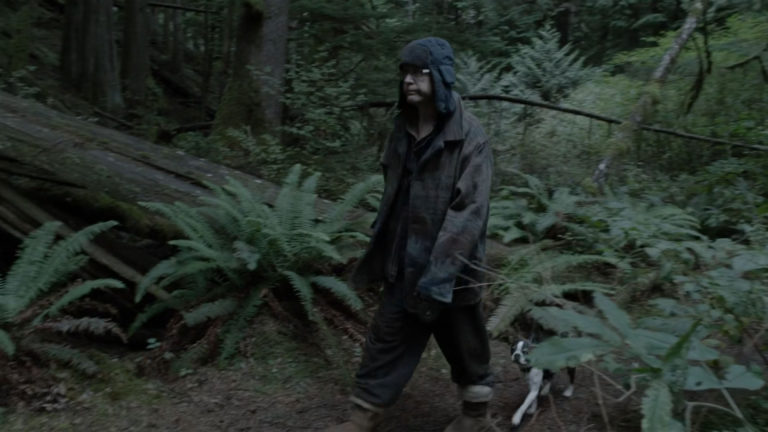 Cyril Pons walking a dog in the woods