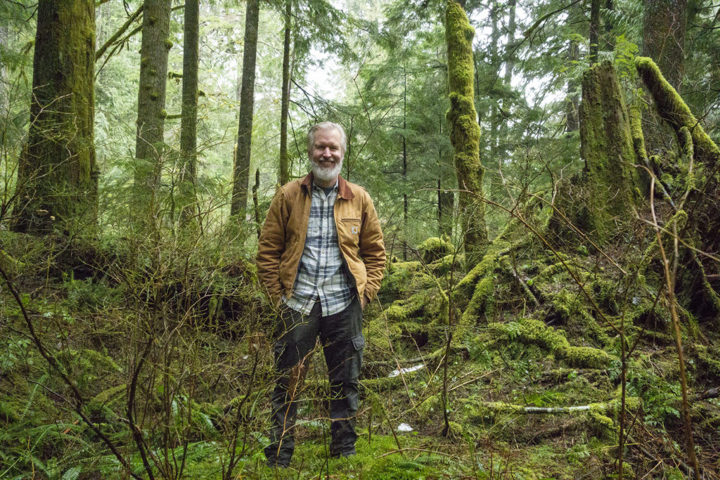 Steven standing in forest with moss-covered trees