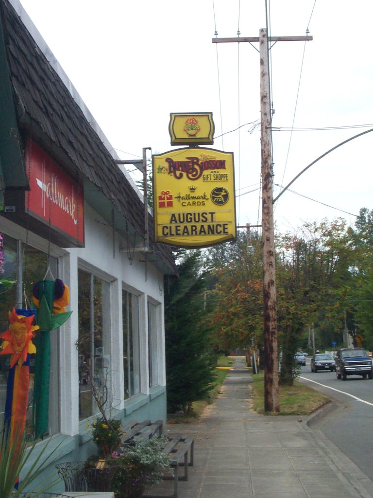 Front of Alpine Blossom and Gift Shoppe with yellow marquee.