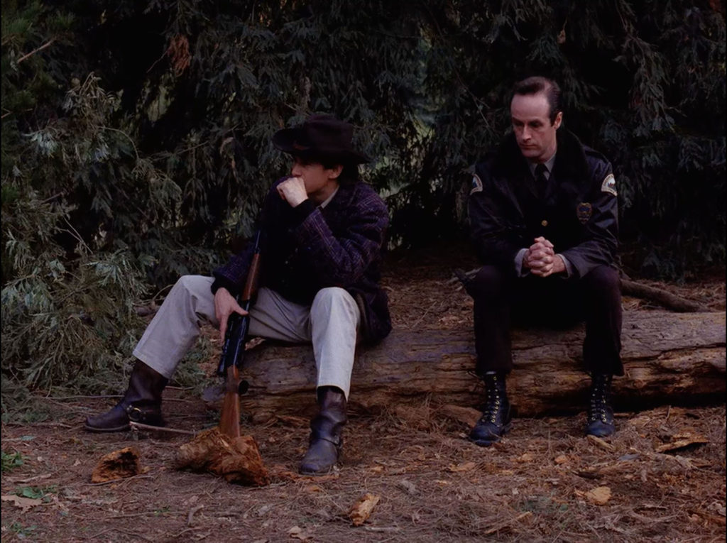 Sheriff Truman and Deputy Andy sitting on a log