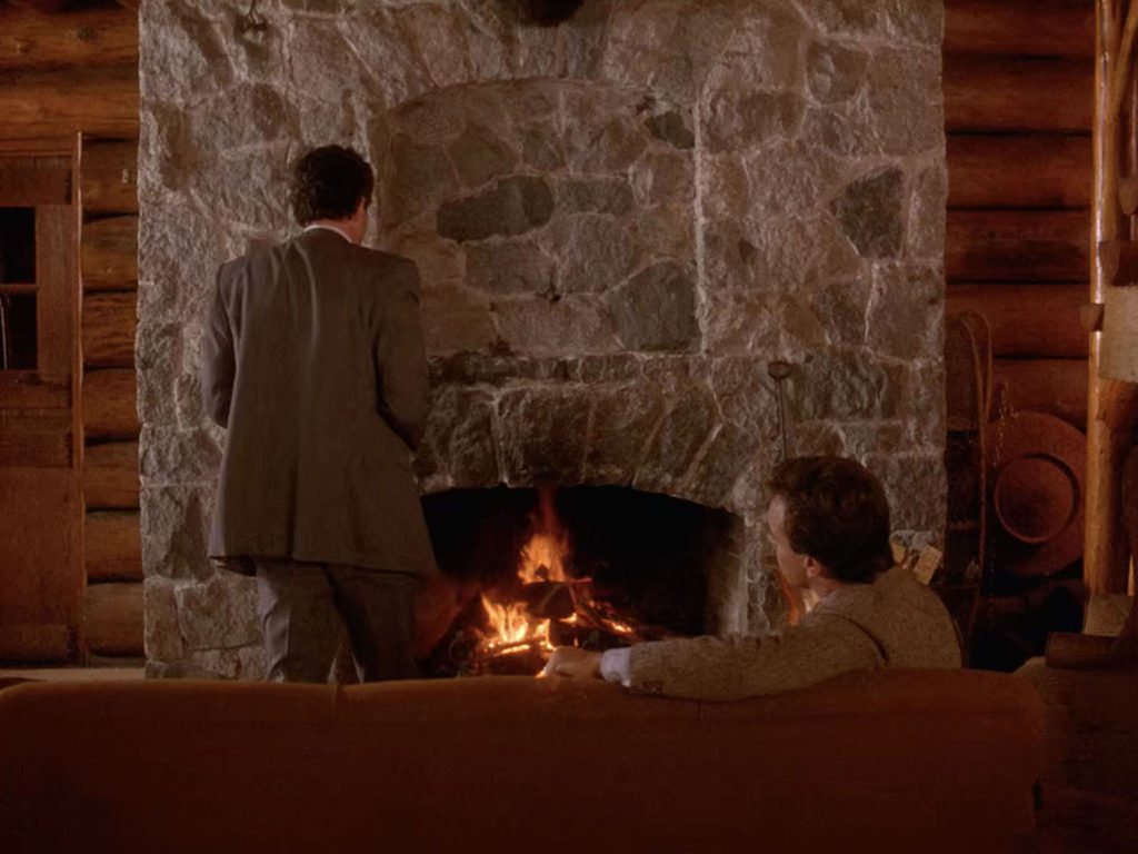 Ben Horne and Leland Palmer by a fireplace