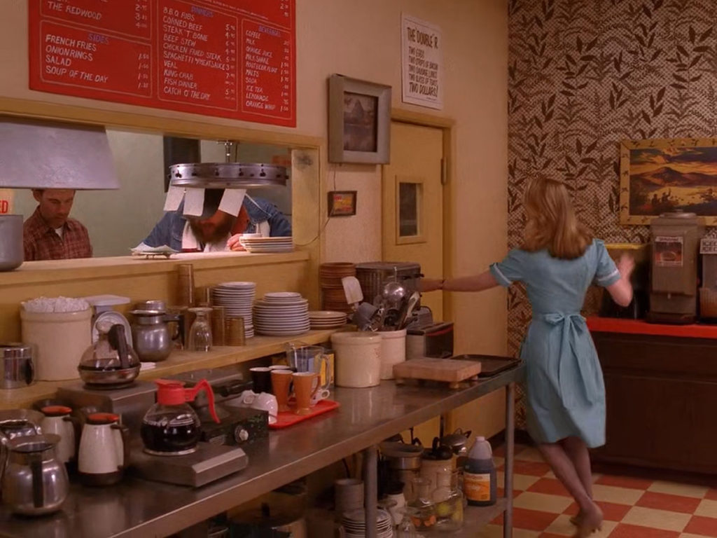 Norma Jennings running toward the kitchen door