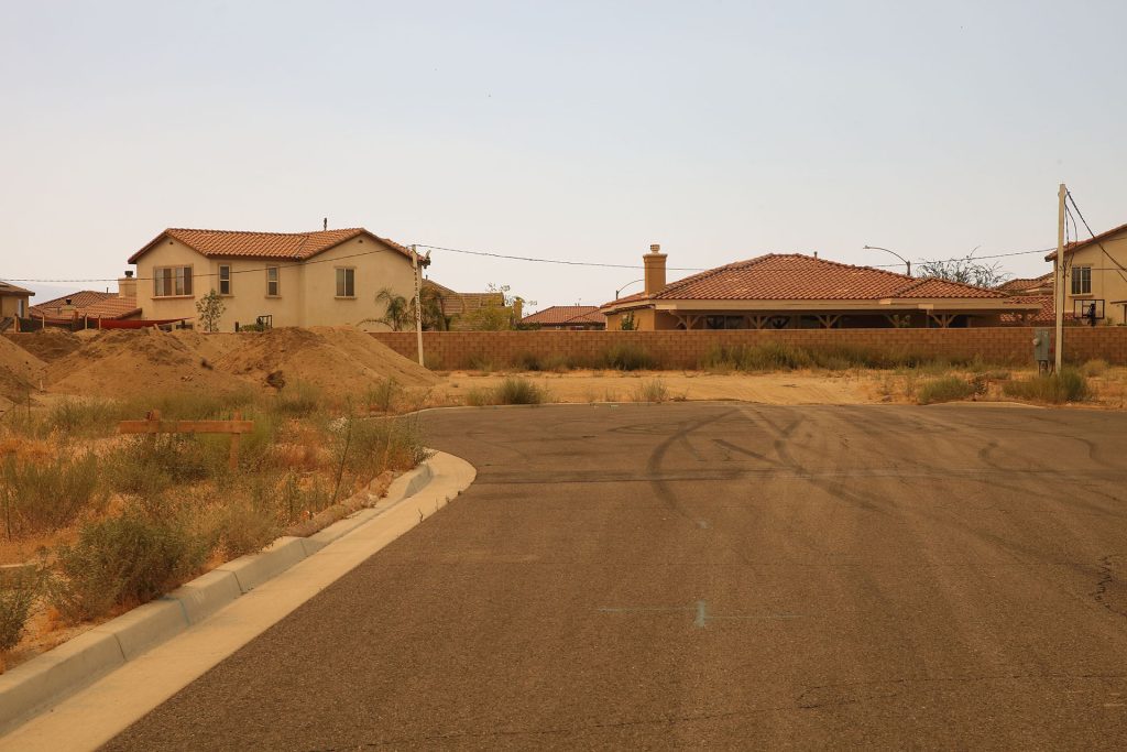 Empty street with house in distance