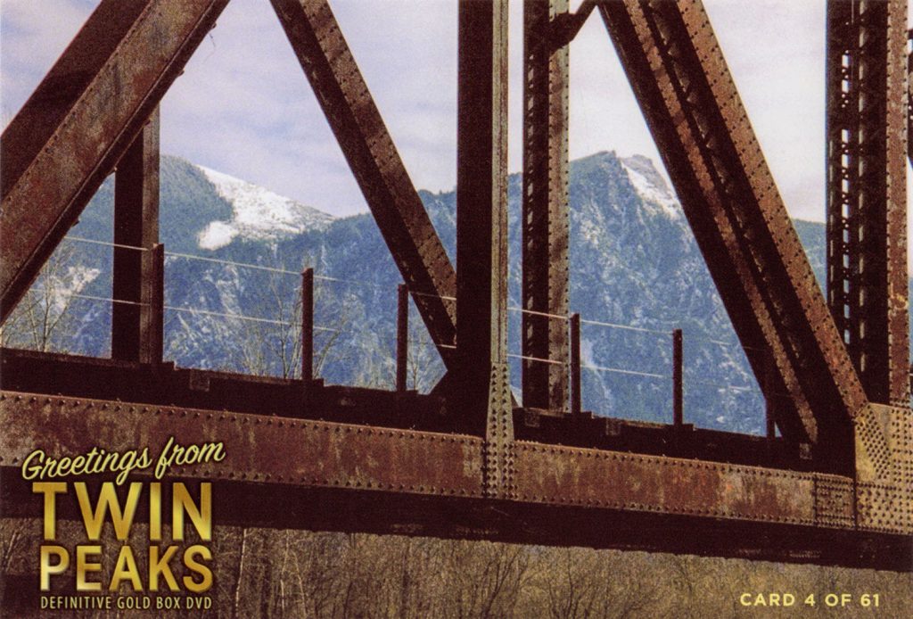 Greetings from Twin Peaks DVD Postcards bridge in front of snow-covered mountains