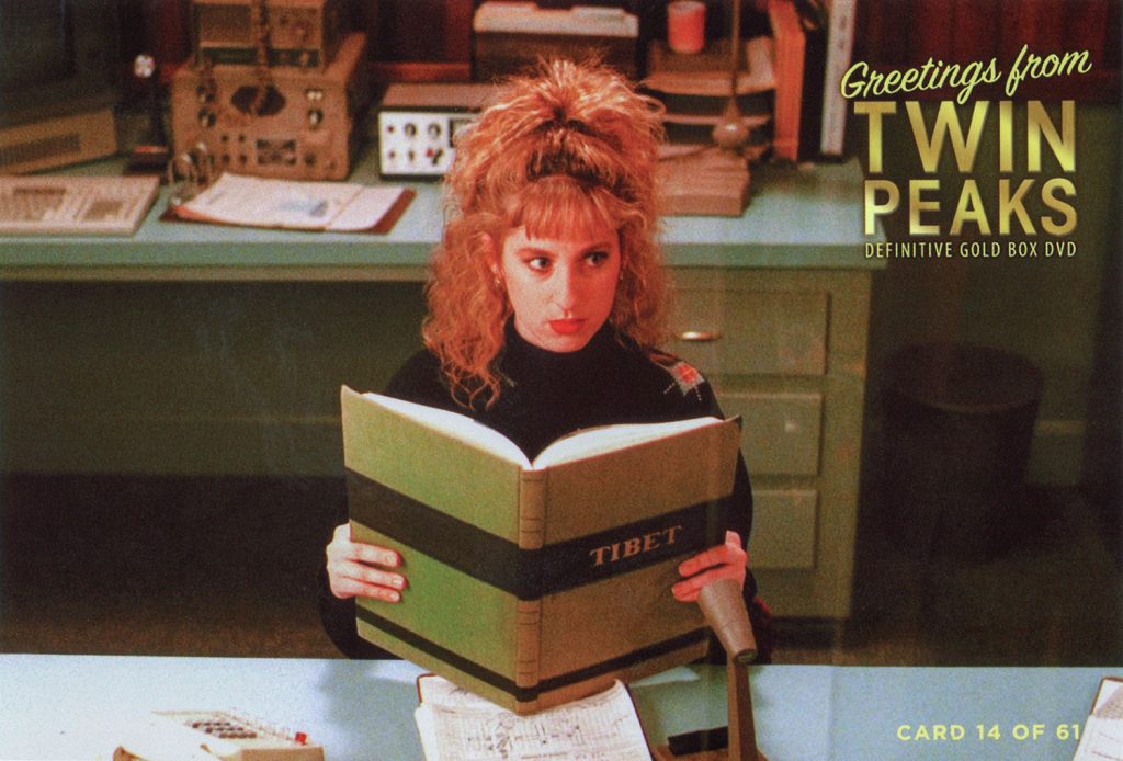 Greetings from Twin Peaks DVD postcards Lucy Moran sitting at Desk reading a book about Tibet