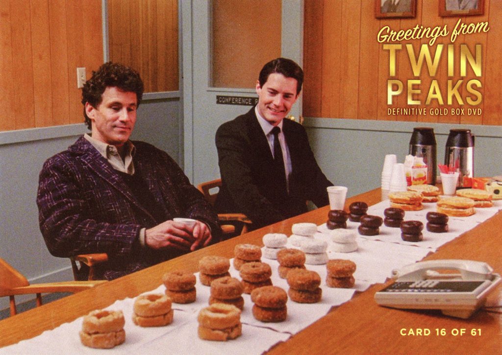 Greetings from Twin Peaks DVD Postcards Two people sitting at table full of doughnuts
