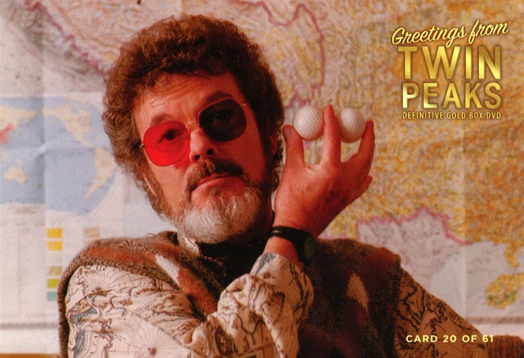 Greetings from Twin Peaks DVD Postcards Dr. Jacoby holding up two golf balls in front of a map