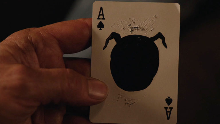 Mr. C holding a playing card