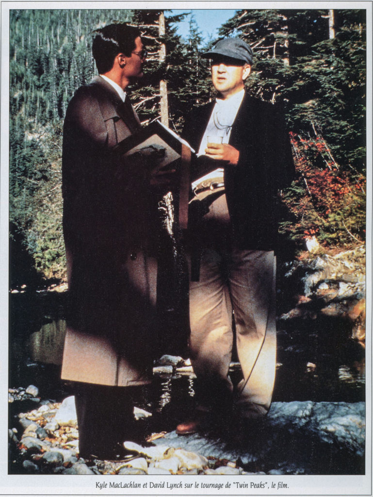 Kyle MacLachlan dressed as Agent Cooper standing next to David Lynch at Olallie State Park in North Bend, Washington. They are discussing a scene from Twin Peaks: Fire Walk With Me.