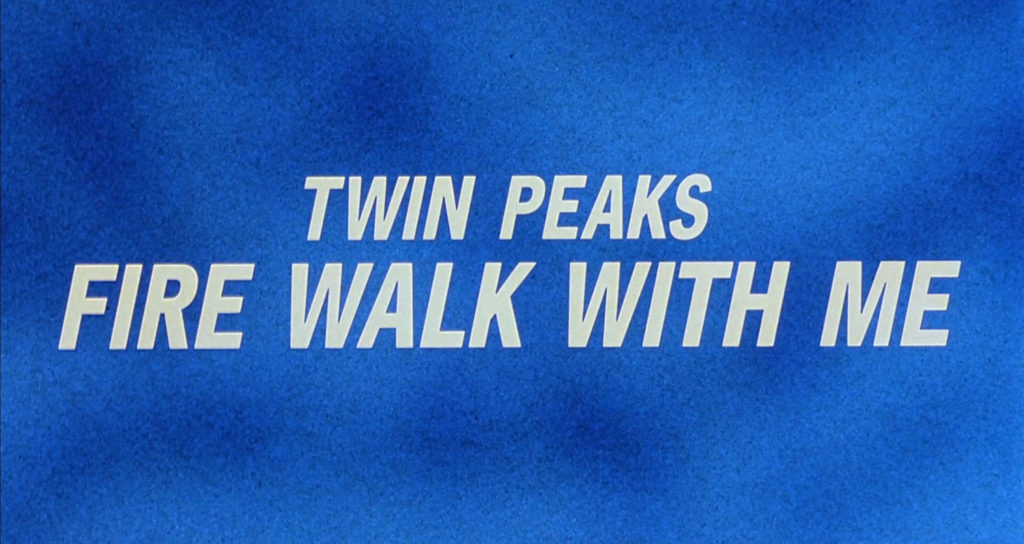 Close up detail of a television screen filled with snow or static in shades of blue. The title Twin Peaks - Fire Walk With Me appears in white lettering.