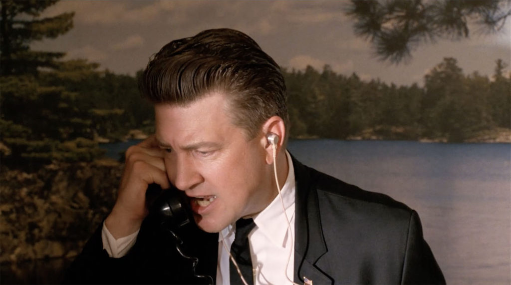 Gordon Cole (David Lynch) yelling into a black handheld telephone