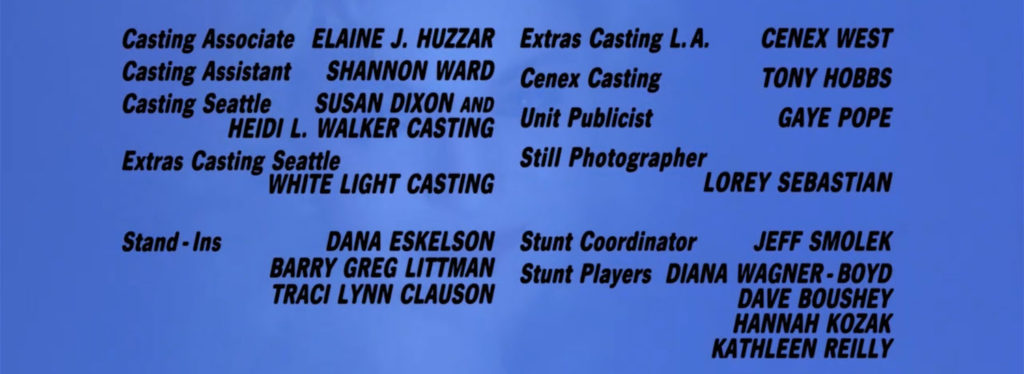 Film credits from Twin Peaks - Fire Walk With Me in black on a blue background with a ghosted image of Laura Palmer smiling.