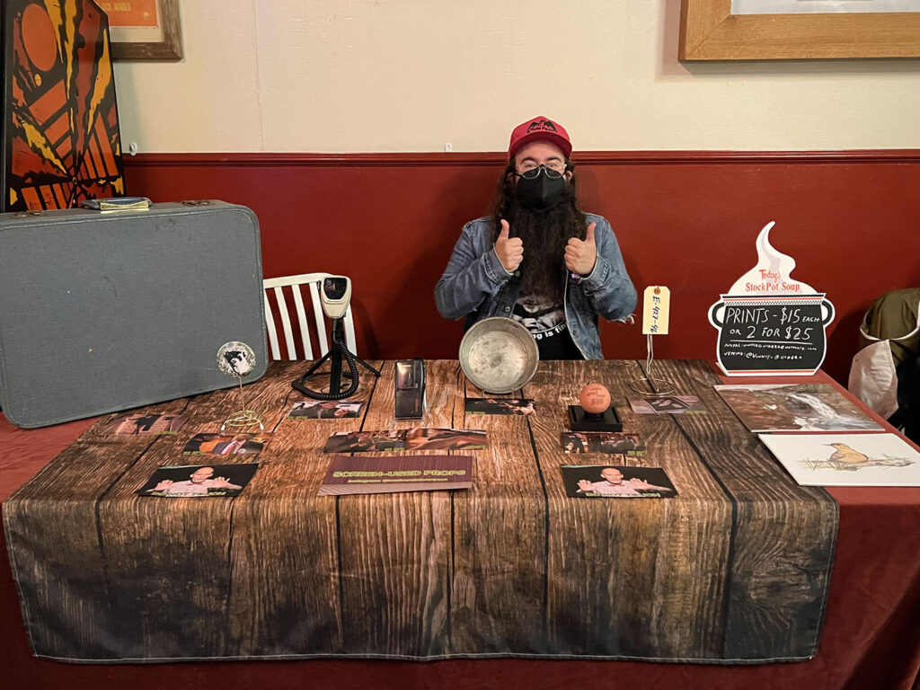 Vinnie sitting behind a table with Twin Peaks props