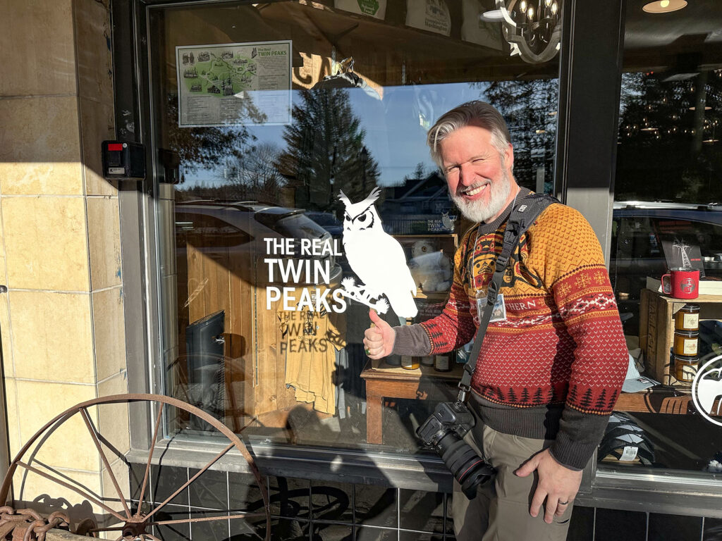 Steven giving a thumbs up sign next to an owl graphic with the words "The Real Twin Peaks" 