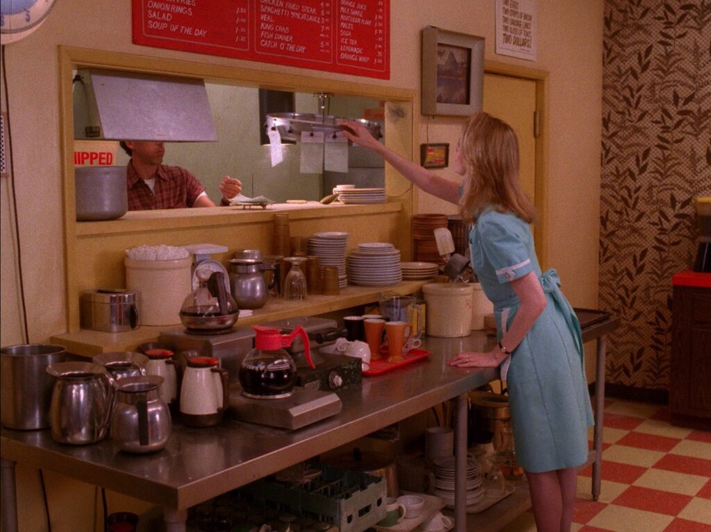 Norma Jennings reaching for the order holder in the Double R Diner