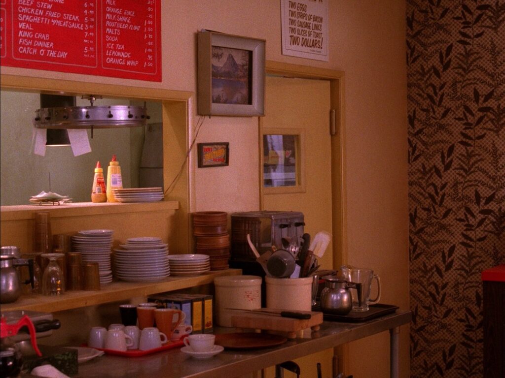 Double R Diner interior with stacked plates and utensils