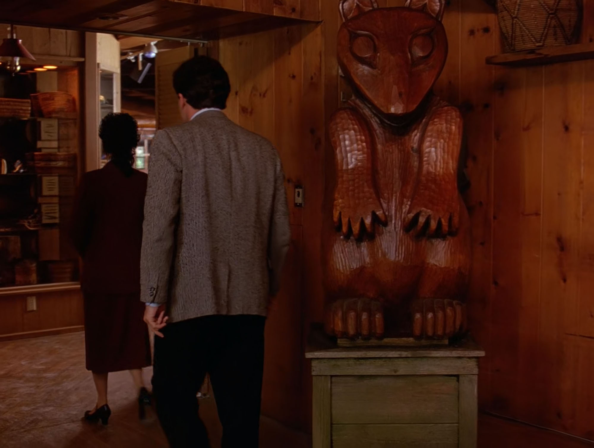 Leland Palmer leaving the dining room passing the carved bear