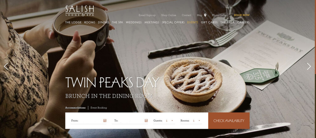 Website carousel image of lady holding cup of coffee with a small cherry pie on the table.