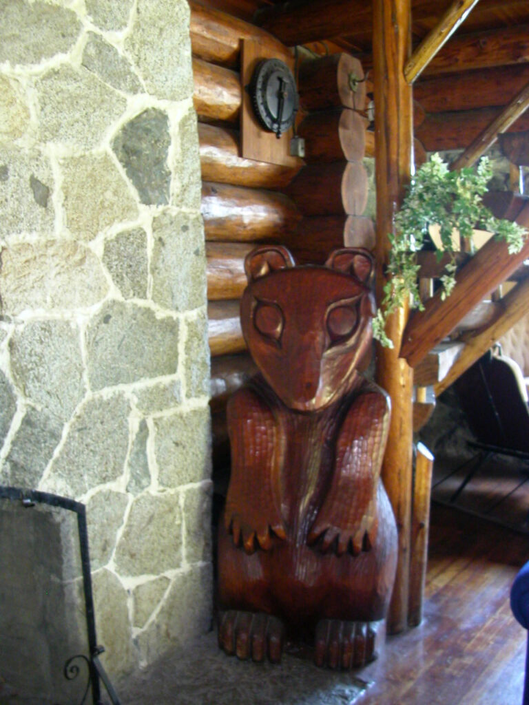 Carved bear by the fireplace.