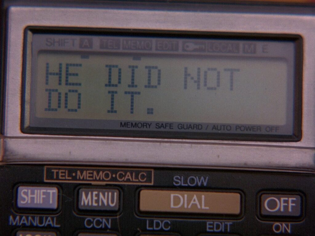 Close up of Dial Master with words "HE DID NOT DO IT."