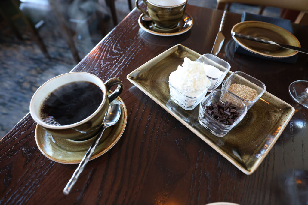 Coffee service at The Dining Room in the Salish Lodge with a cup of black coffee and a condiment tray