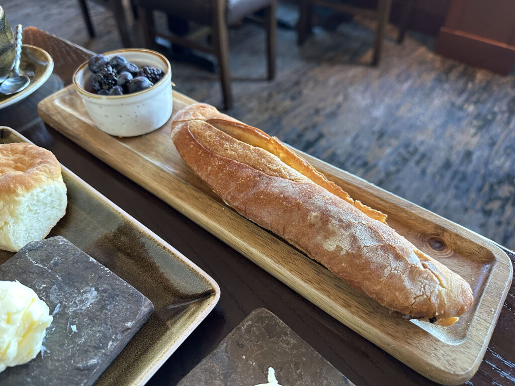 Baguette with a small container of fruit