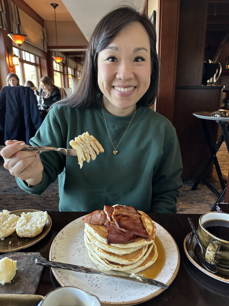 Katie holding a bite of griddle cakes
