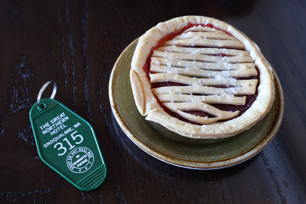 Room 315 green key tag and a small cherry pie.