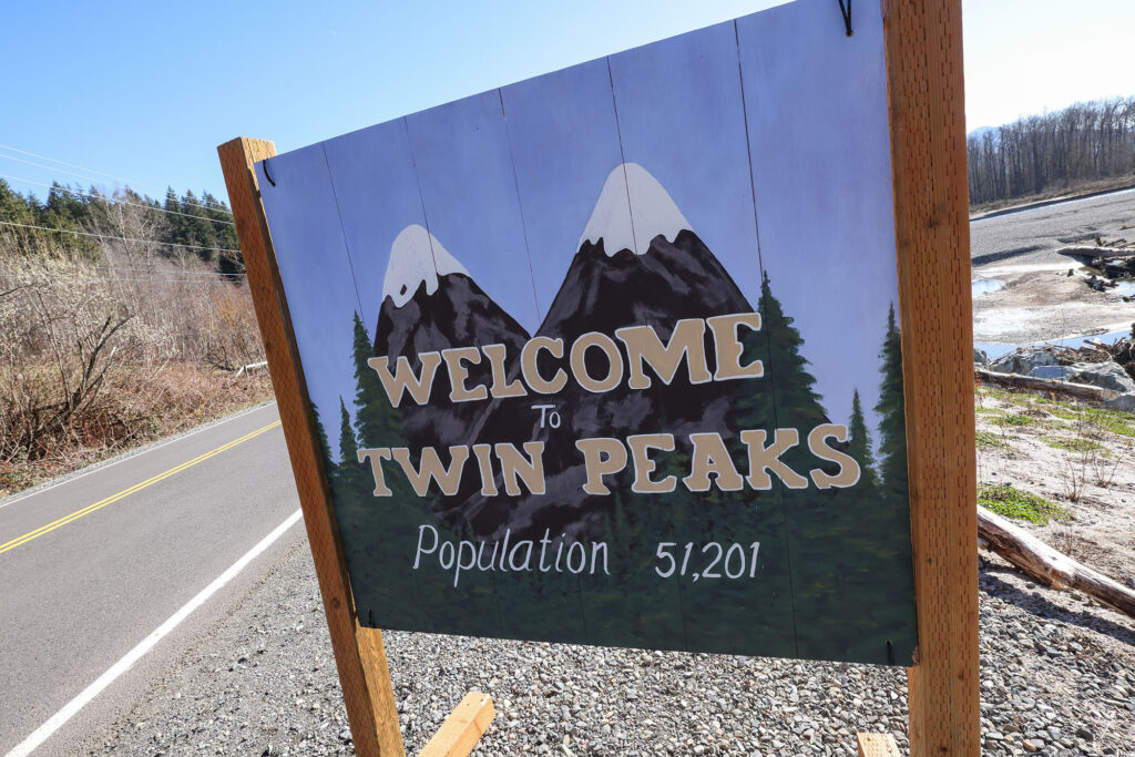 Welcome to Twin Peaks sign along side of the road