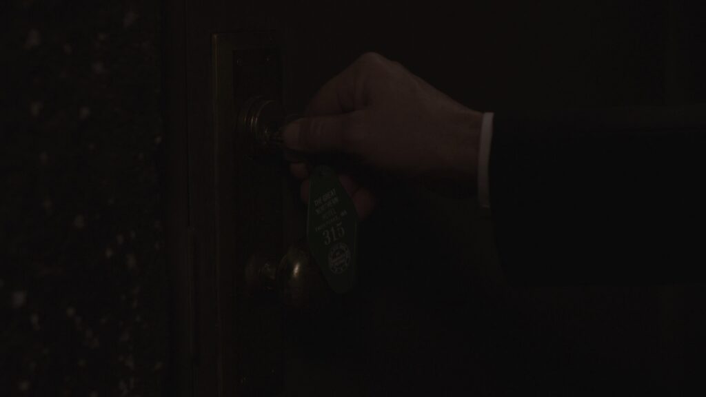 Cooper's hand by door knob